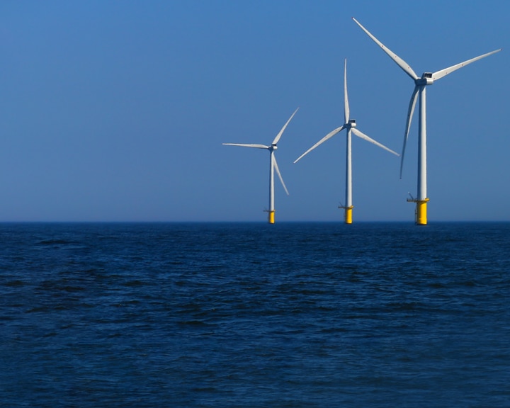 view of windmills of Rampion windfarm off the coast of Brighton, Sussex, UK