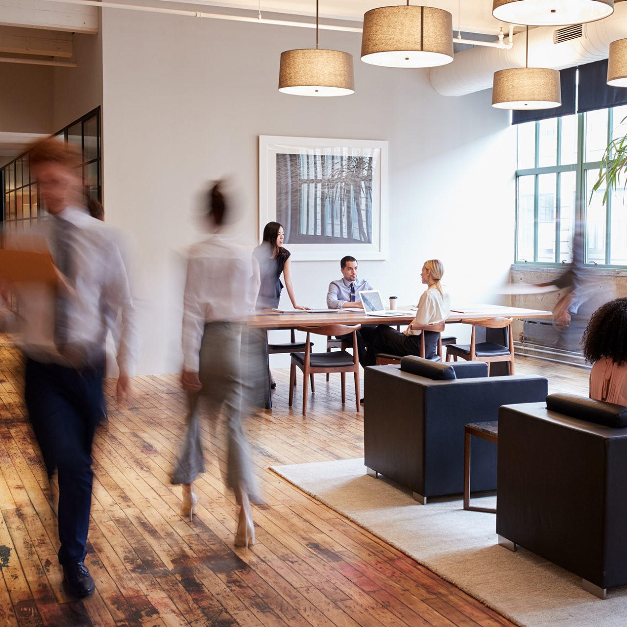 Business people at work in a busy luxury office space