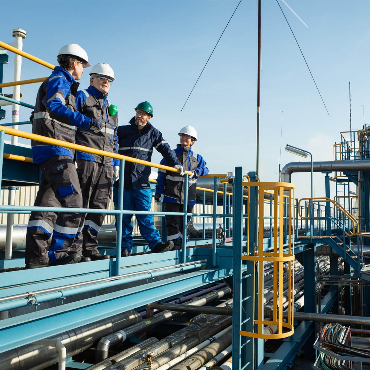 A group of people inspecting a green hydrogen production plant